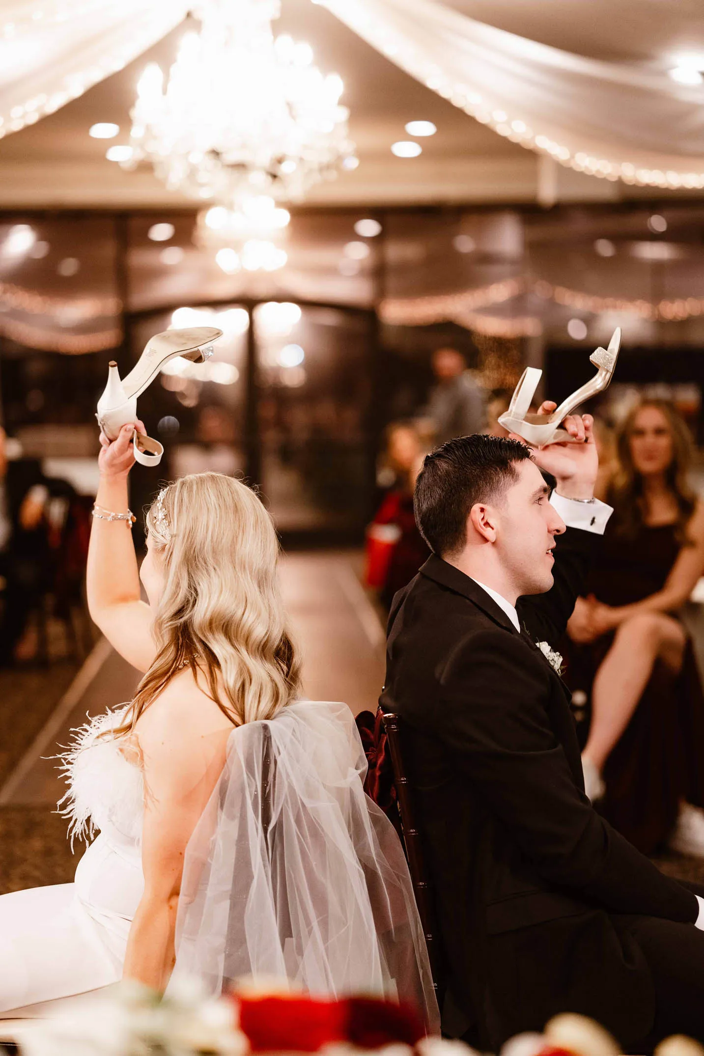 kylie-and-jeremy-wedding-laughing-during-shoe-game-with-heels-raised-photo-phoenix-arizona